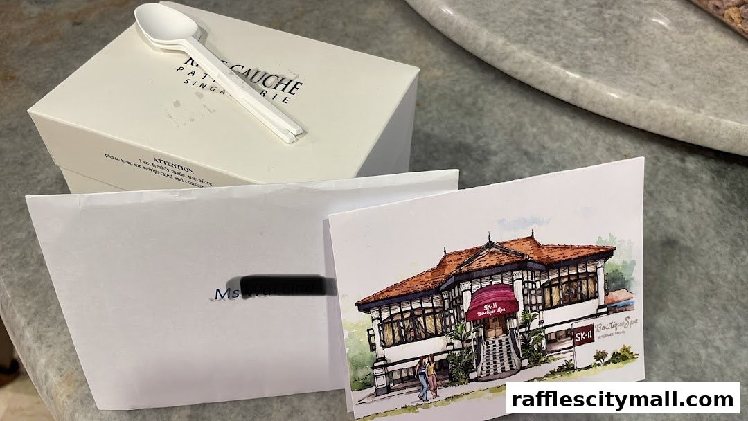 A box of pastries and a postcard depicting a spa building.