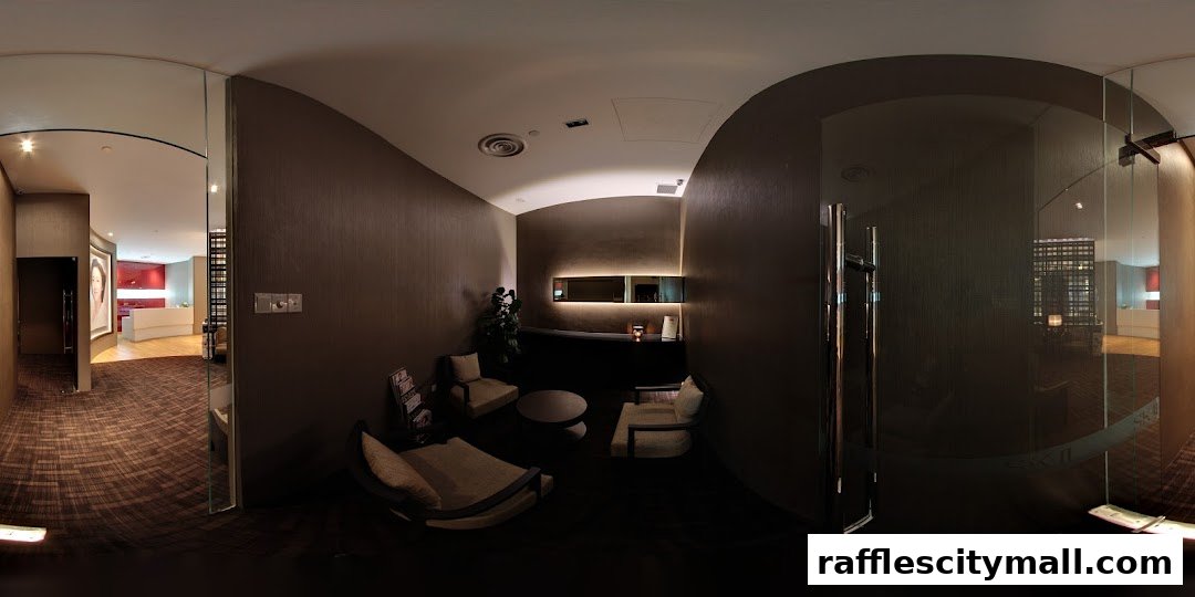 Interior view of a modern spa waiting area with comfortable seating and a reception desk.