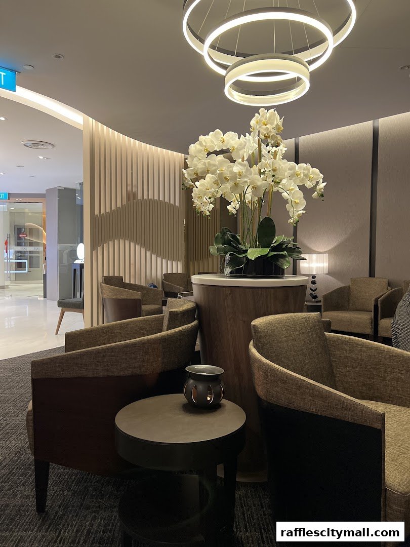 A luxurious spa waiting area with comfortable seating, elegant lighting, and a large floral arrangement.