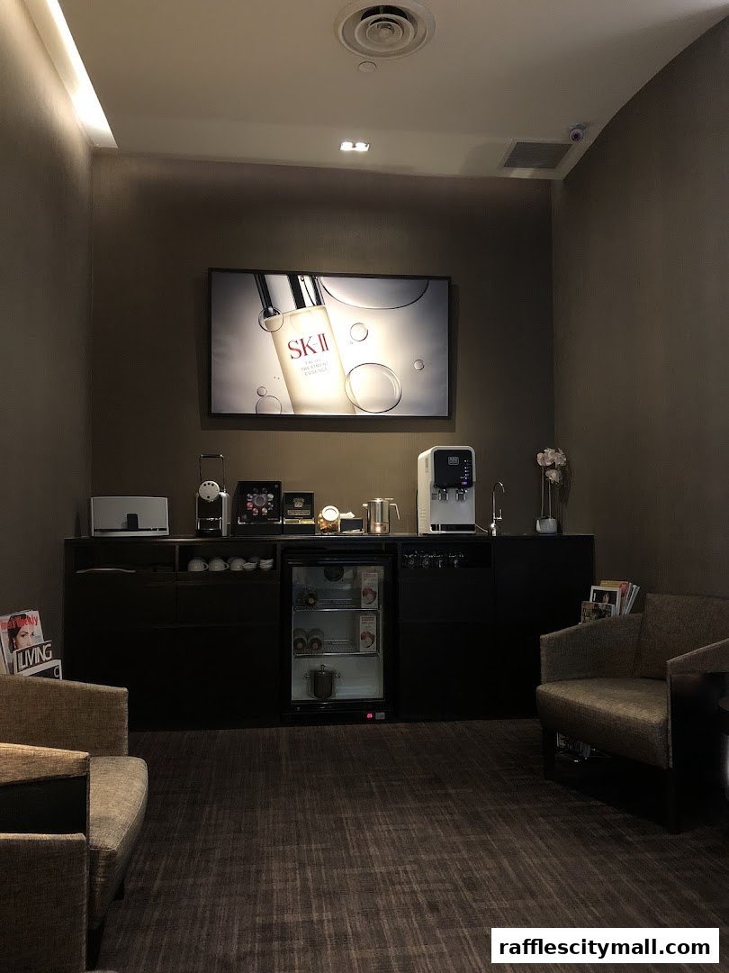 Interior waiting area of a spa with comfortable seating and a refreshment station.
