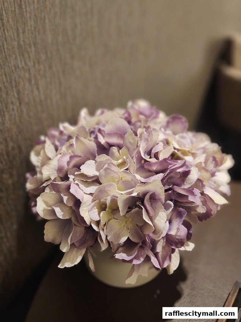 A close-up shot of a vase filled with delicate purple and white hydrangeas.