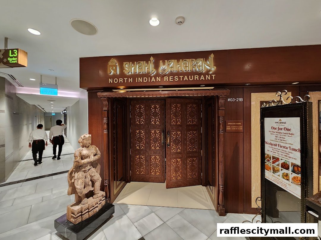 The entrance to Shahi Maharani North Indian Restaurant, featuring ornate wooden doors and a decorative statue.