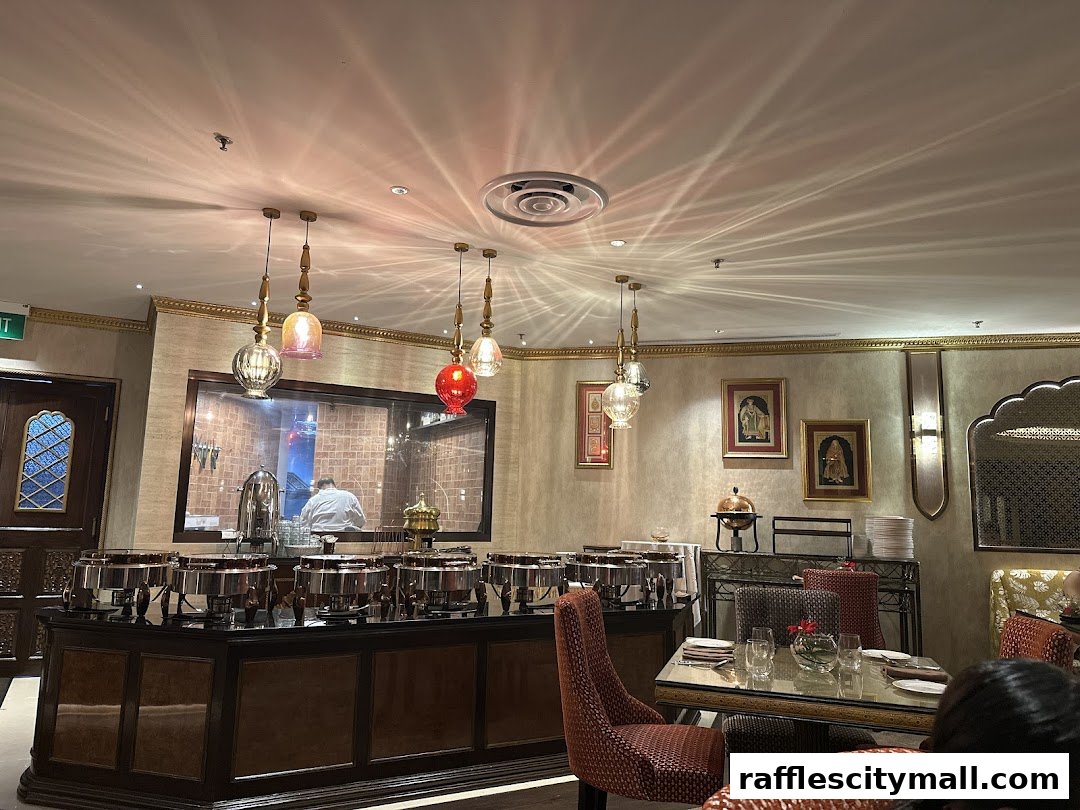 Interior of a North Indian restaurant with a buffet setup and dining tables.