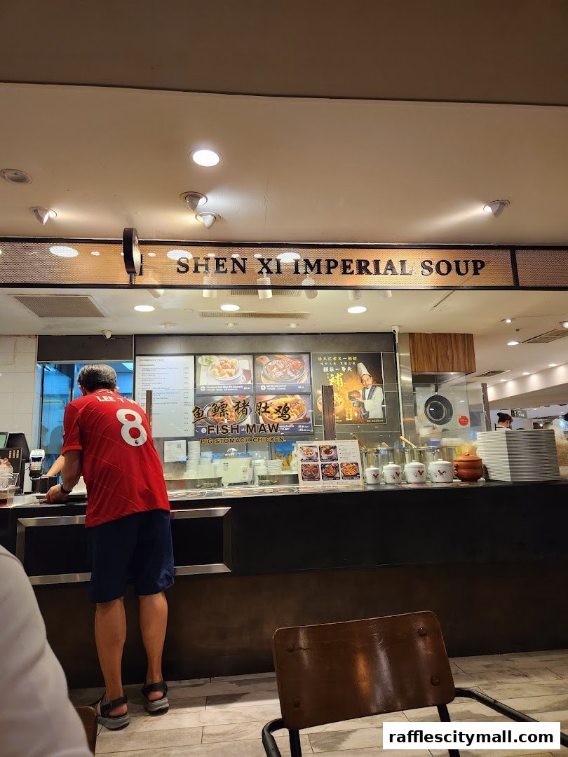 A person in a red shirt stands at the counter of Shen Xi Imperial Soup.