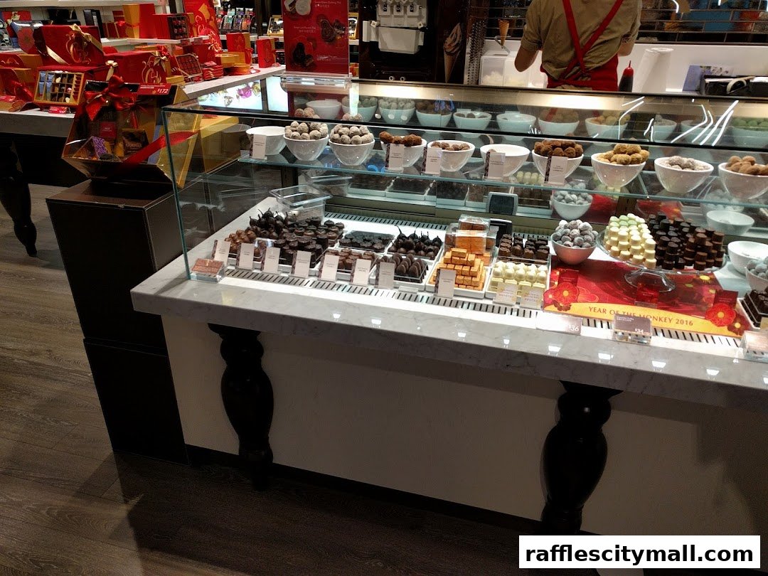 A display case filled with various chocolates and gift boxes at a Godiva store.