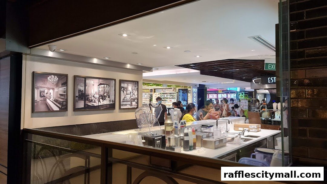 Interior view of a Godiva chocolate shop with customers and a service counter.