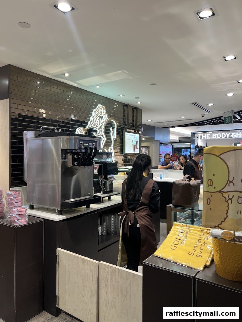 A Godiva shop with staff preparing drinks and displaying chocolates.