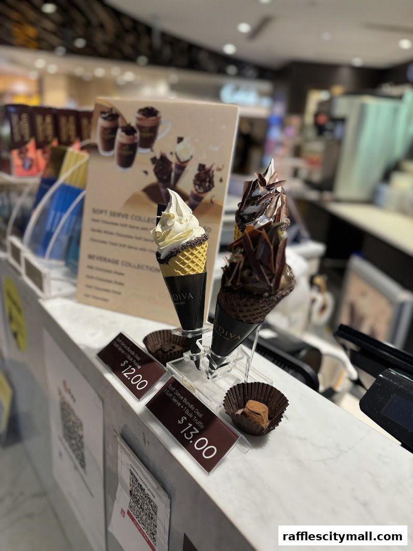 Godiva soft serve ice cream cones with chocolate decorations and pricing displayed.