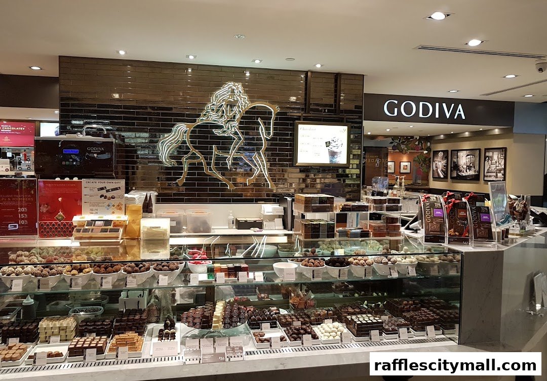 A well-lit Godiva chocolate shop display featuring a wide assortment of chocolates and truffles.