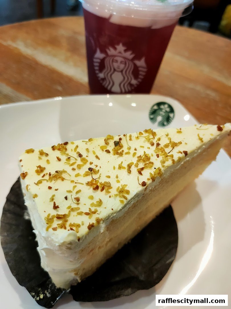 A slice of cake with white frosting and a drink with the Starbucks logo.