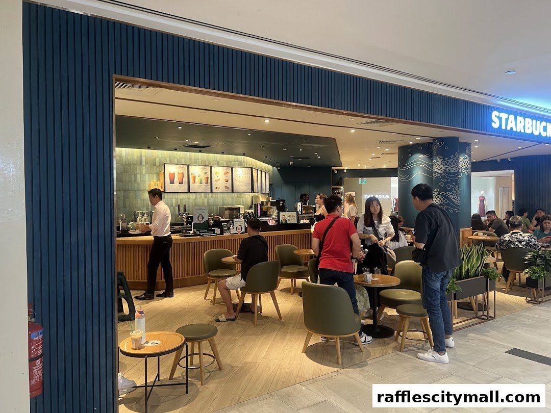 People enjoying coffee at Starbucks Raffles City, with a barista serving customers.