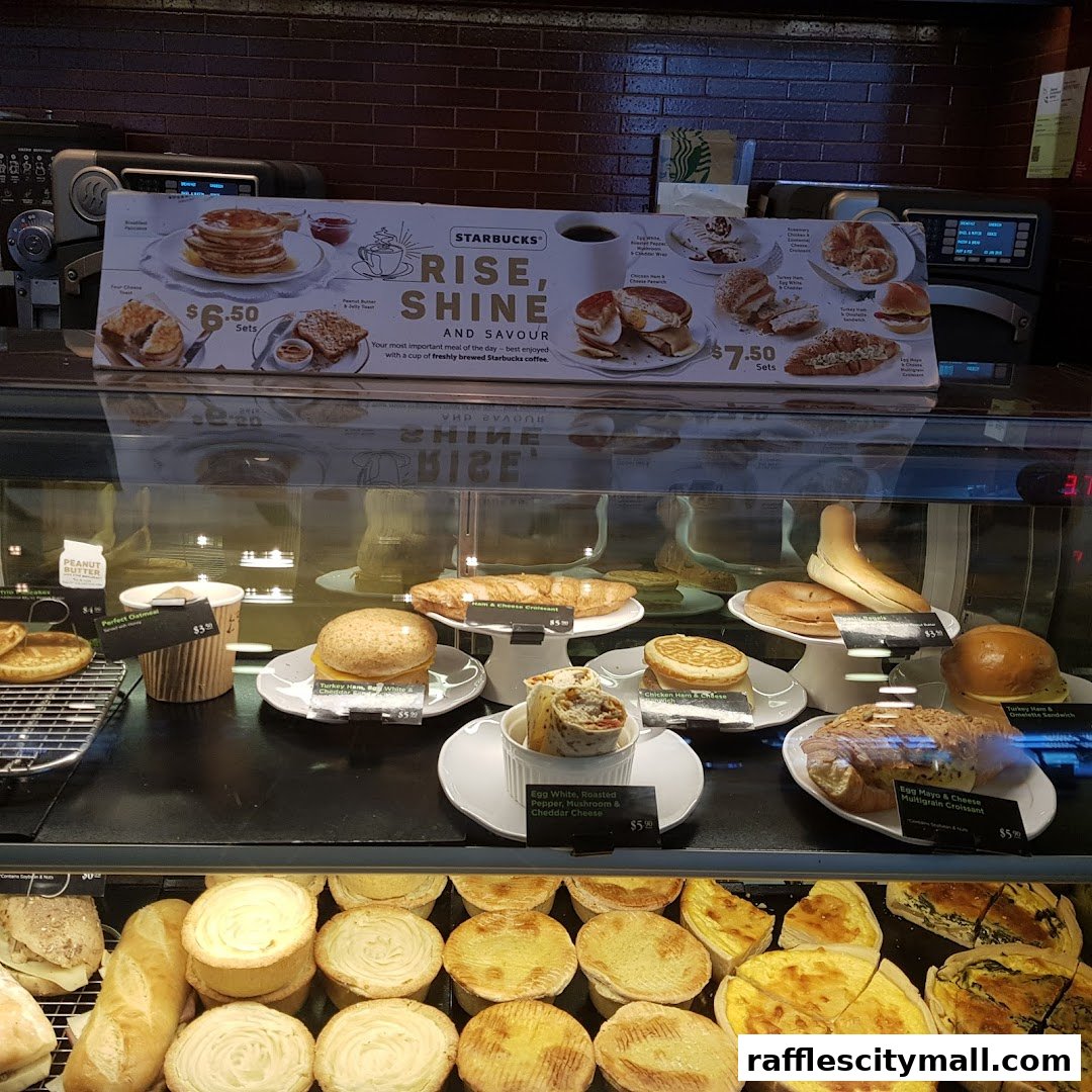 A display case filled with various Starbucks breakfast items and pastries.