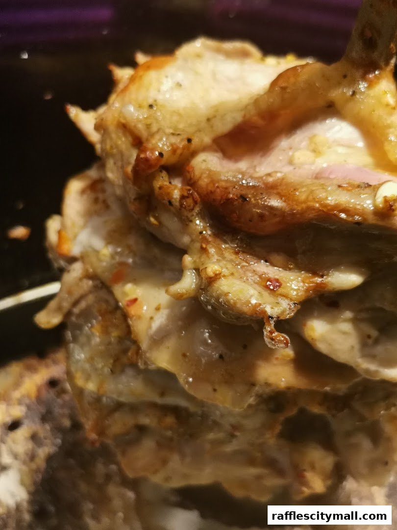 A close-up shot of a rotating spit of seasoned meat, likely for shawarma or döner kebab.