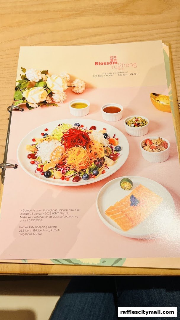 A menu page from Sufood featuring a colorful Yusheng salad and salmon sashimi.