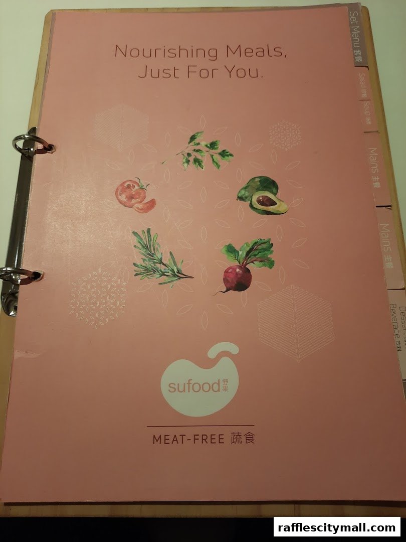 A pink menu cover for Sufood, featuring "Nourishing Meals, Just For You" and "MEAT-FREE".