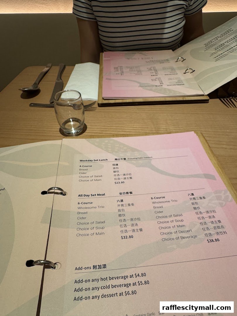 A table setting with menus and cutlery, featuring a person in the background.