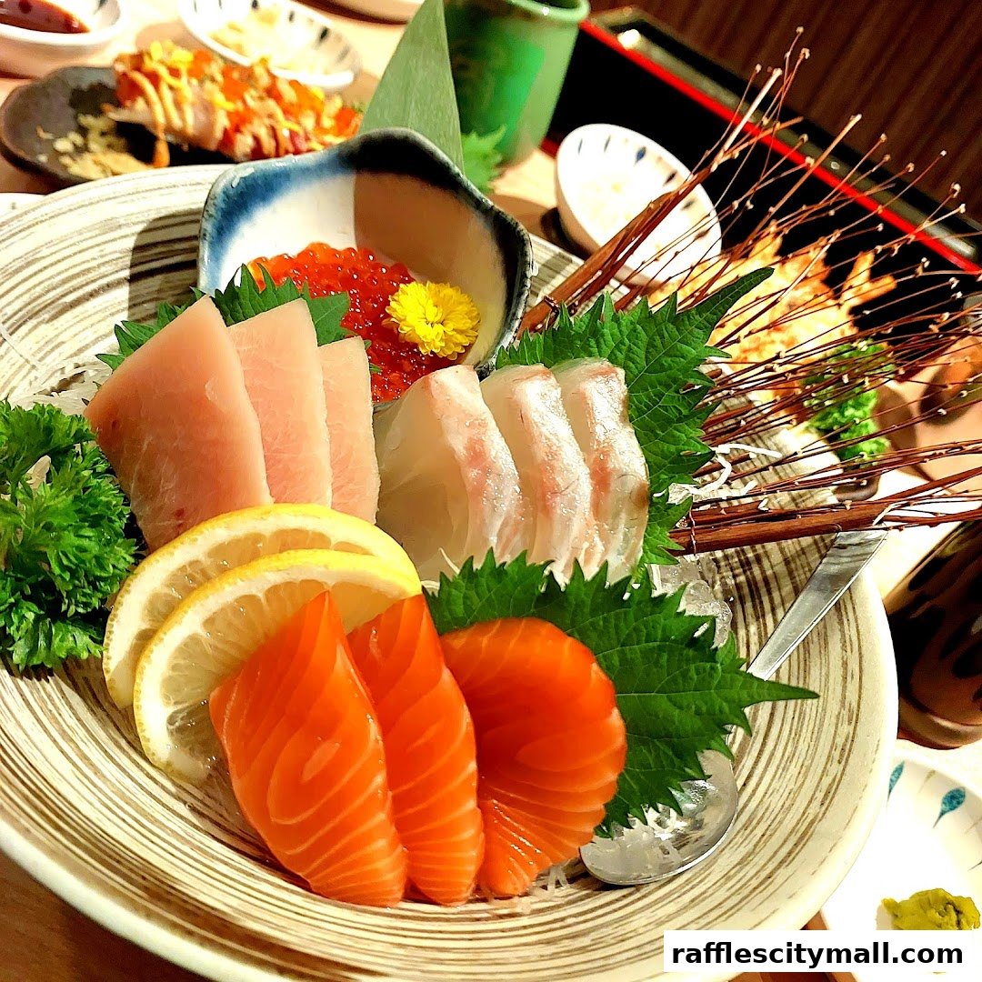 A close-up of a vibrant sashimi platter featuring salmon, tuna, and white fish with ikura and lemon slices.