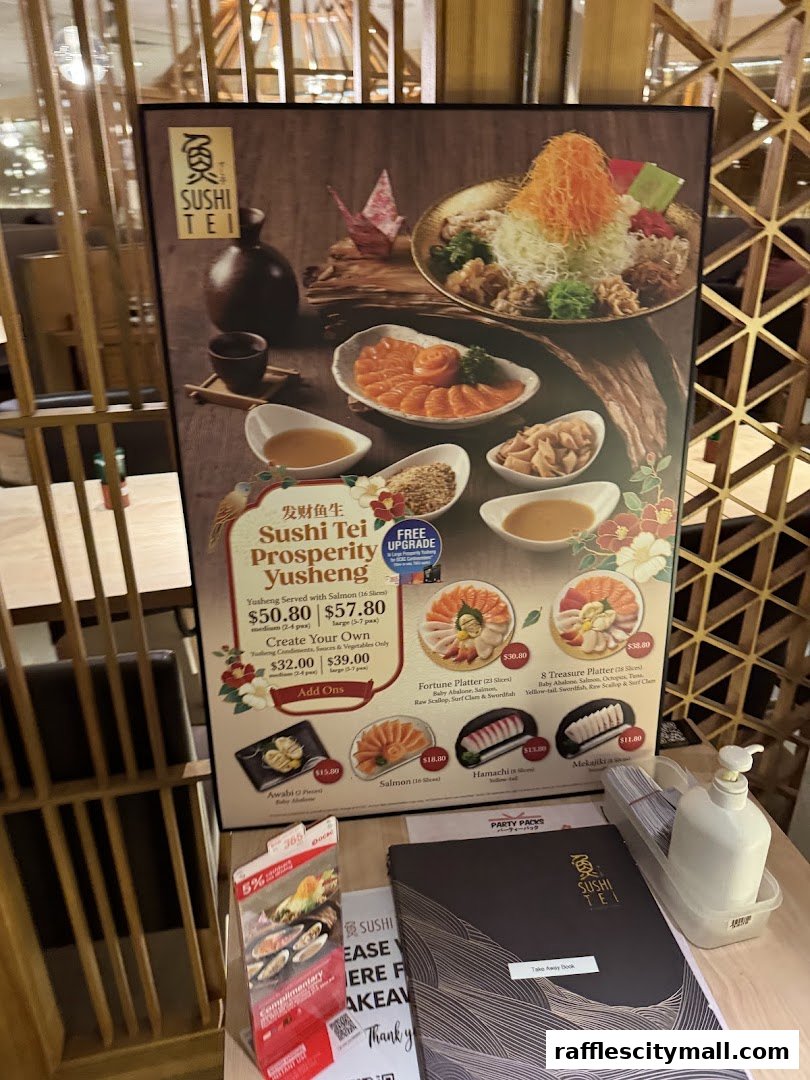 A promotional poster for Sushi Tei featuring various sushi platters and a Prosperity Yusheng dish.