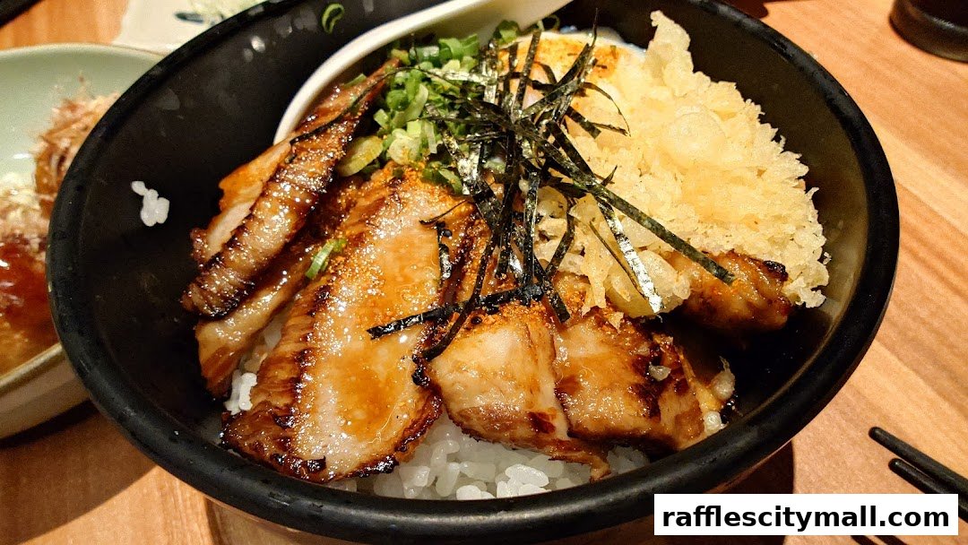 A close-up of a delicious Japanese rice bowl with grilled pork, tempura, and seaweed.