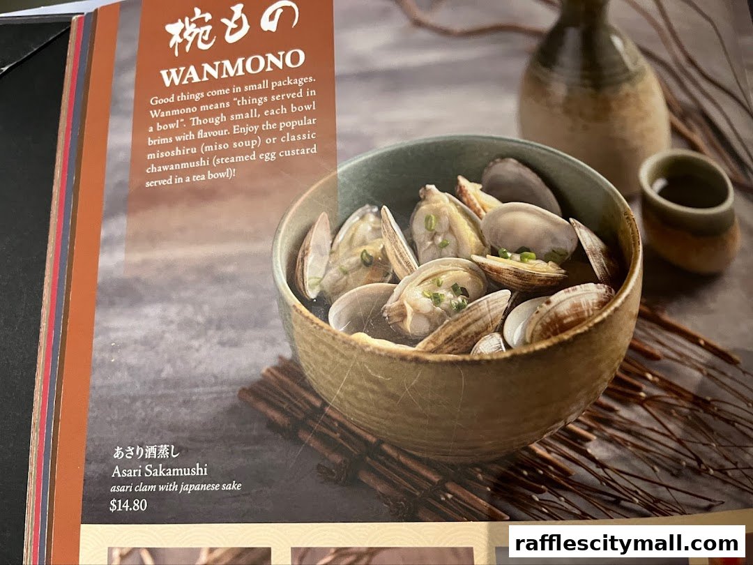 A menu item featuring a bowl of clams cooked with Japanese sake.