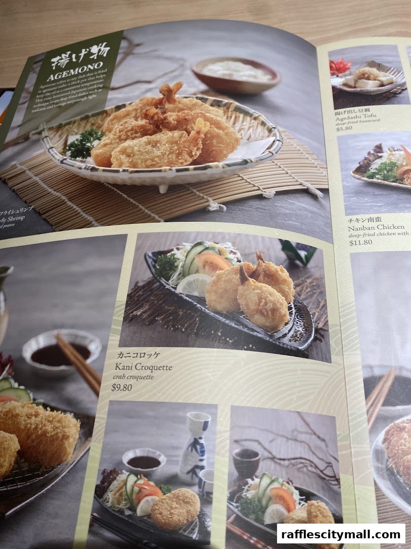 A menu page from Sushi Tei featuring various fried Japanese dishes like shrimp and crab croquettes.