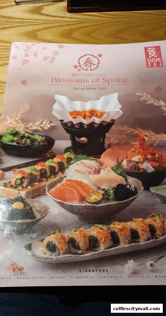 A menu from Sushi Tei featuring a 'Blossoms of Spring' promotion with various sushi dishes.