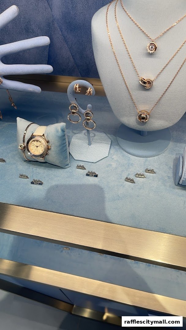 A display window showcasing rose gold jewelry, including necklaces, earrings, and a watch.