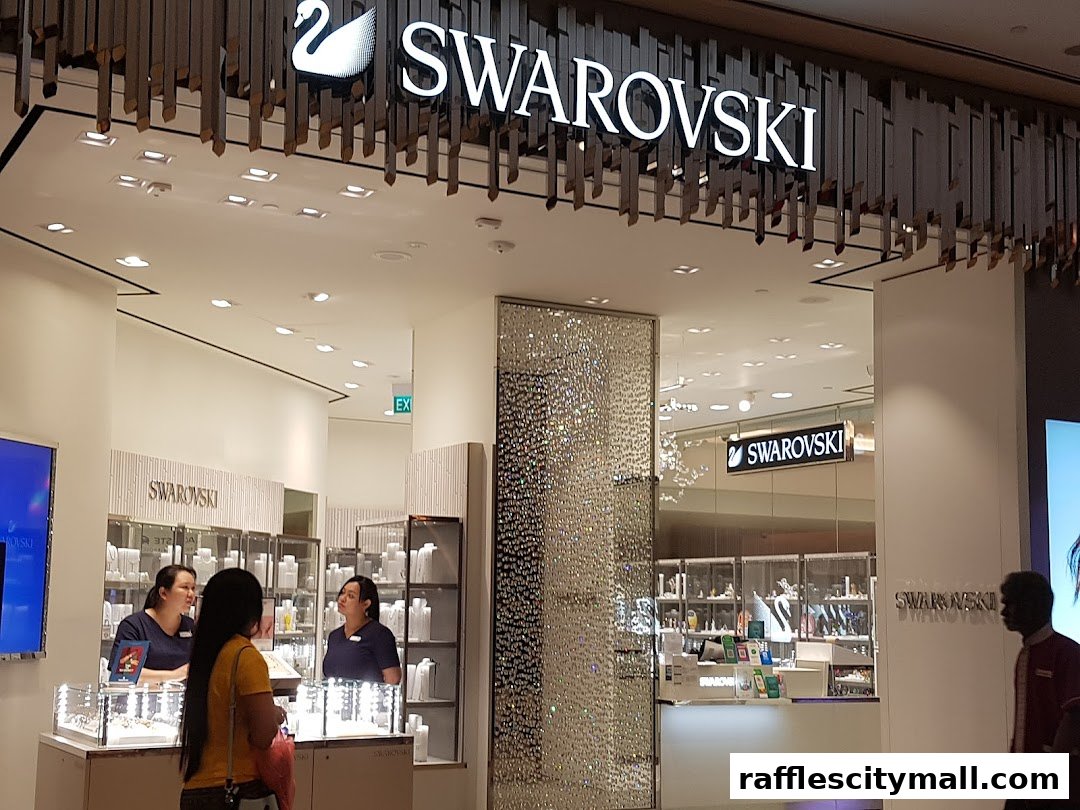 The entrance of a Swarovski store with illuminated signage and sparkling crystal displays.