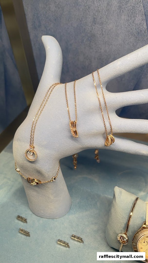 A display of elegant rose gold necklaces and bracelets with sparkling crystals.