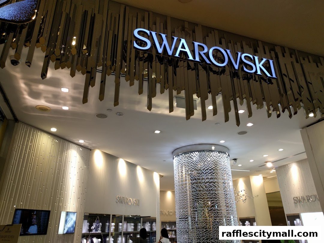 The illuminated Swarovski logo above a shop entrance with a crystal chandelier.