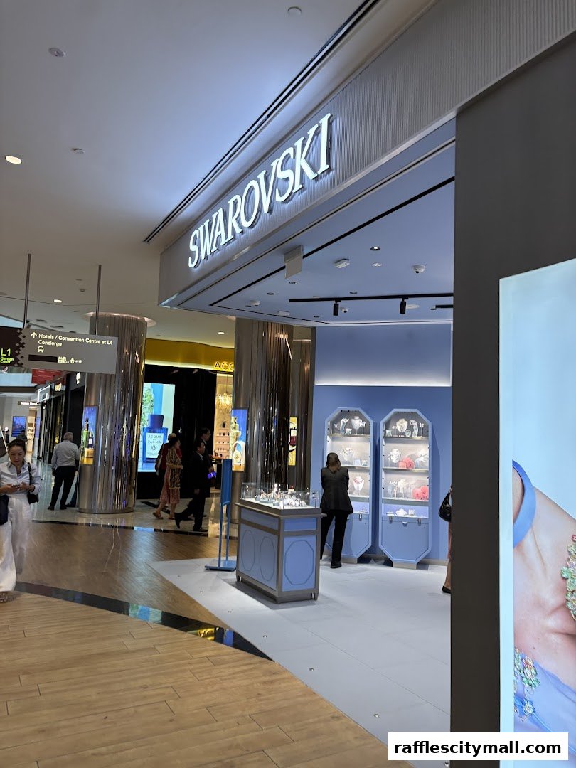 The exterior of a Swarovski store in a shopping mall, showcasing jewelry displays.