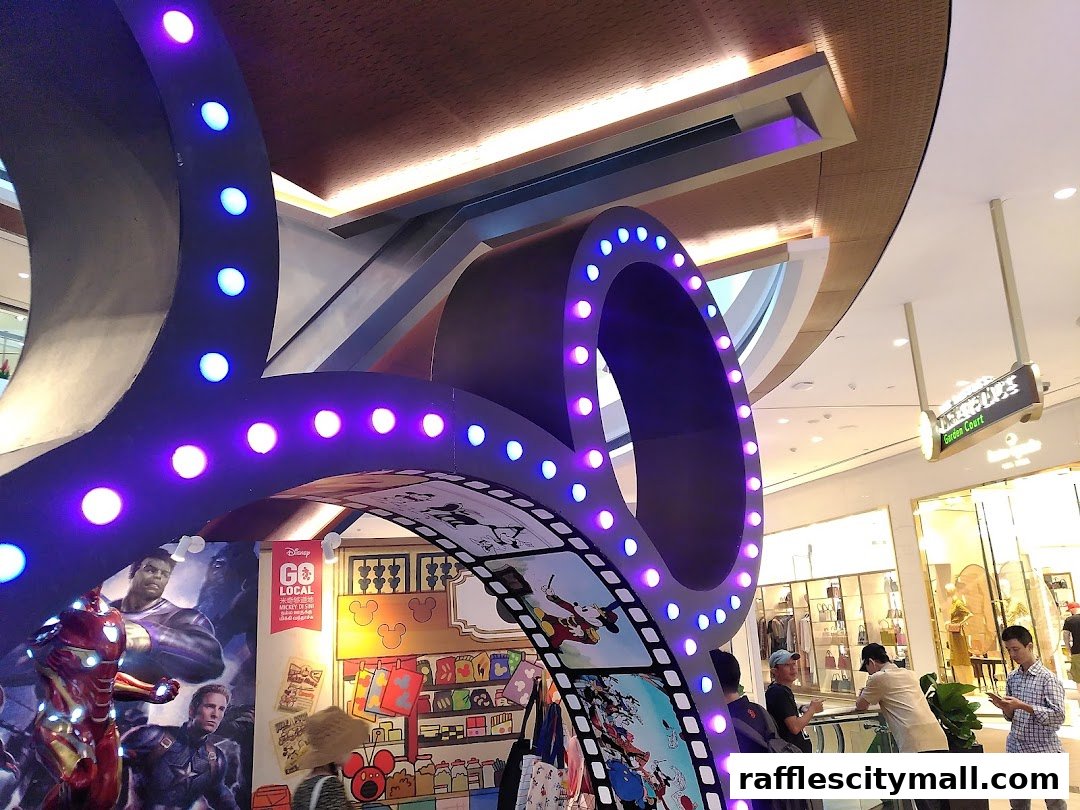 A Disney-themed display with movie characters and lights in a shopping mall.