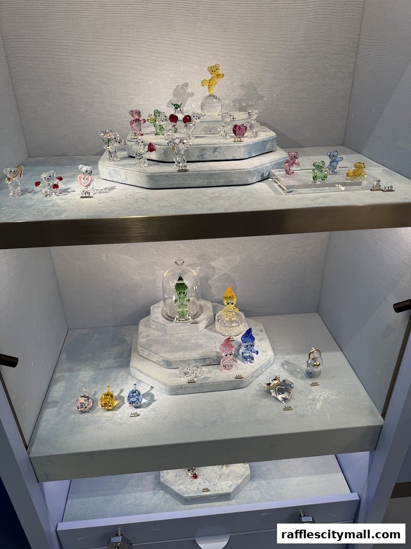 A display case filled with sparkling crystal figurines, including teddy bears and trolls.