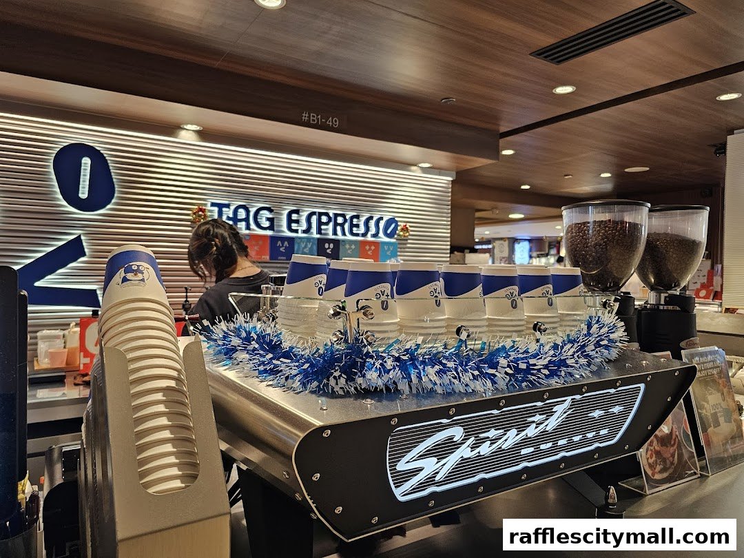 A coffee machine with cups and coffee beans at TAG Espresso.