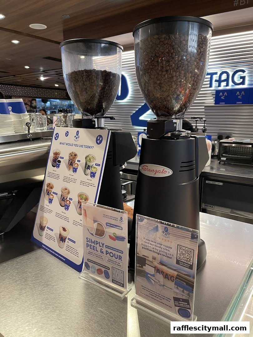 Close-up of coffee grinders and promotional materials at TAG Espresso.