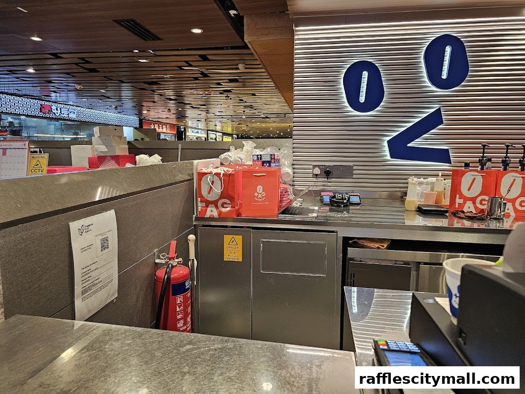 Interior view of TAG Espresso counter with branded bags and a distinctive wall logo.