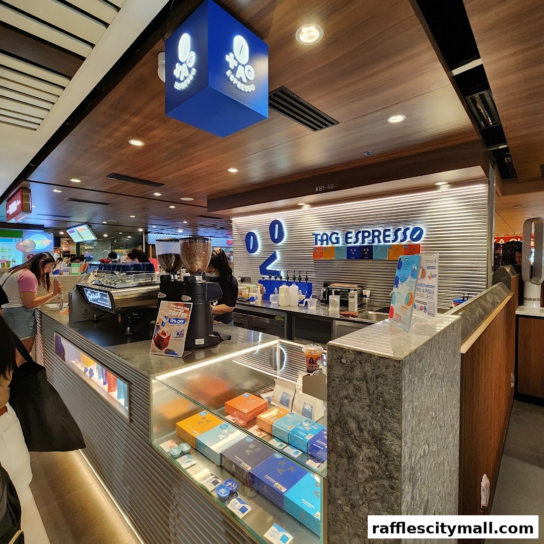 Interior view of TAG Espresso coffee shop with a counter, espresso machine, and display cases.