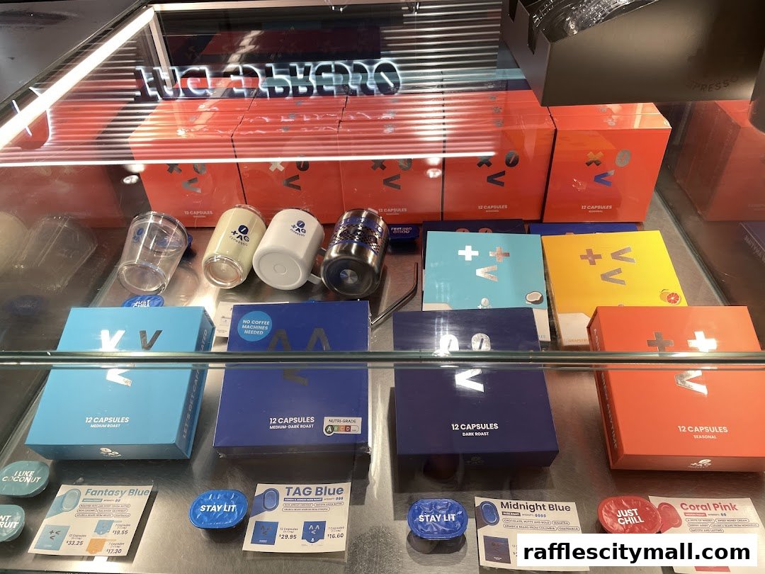 A display case filled with various coffee capsule boxes and branded merchandise from TAG Espresso.