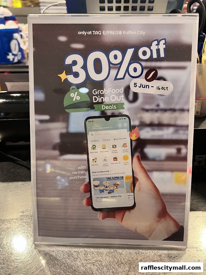 A sign advertising 30% off GrabFood Dine Out Deals at TAG Espresso Raffles City.