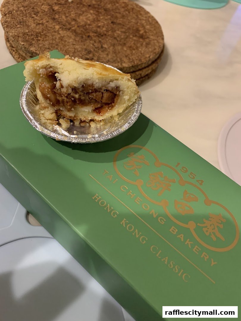 A close-up of a delicious-looking pastry from Tai Cheong Bakery on a green box.