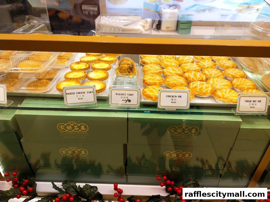 A display case filled with various baked goods, including tarts and pies, from Tai Cheong Bakery.