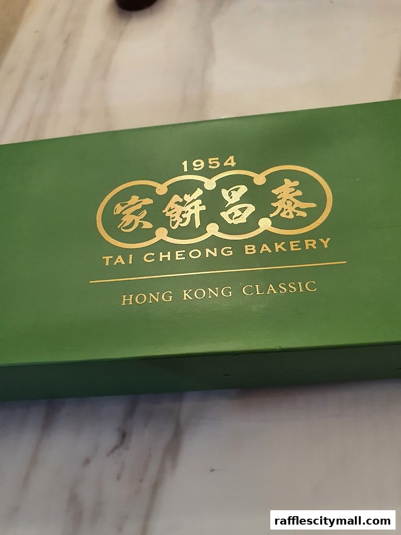 A green box with gold lettering from Tai Cheong Bakery, featuring the year 1954.