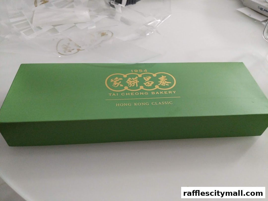 A green gift box from Tai Cheong Bakery with gold lettering.