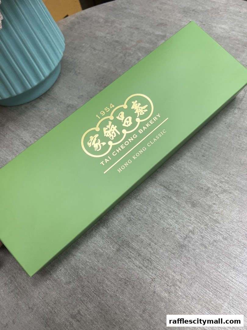 A green gift box with gold lettering from Tai Cheong Bakery.