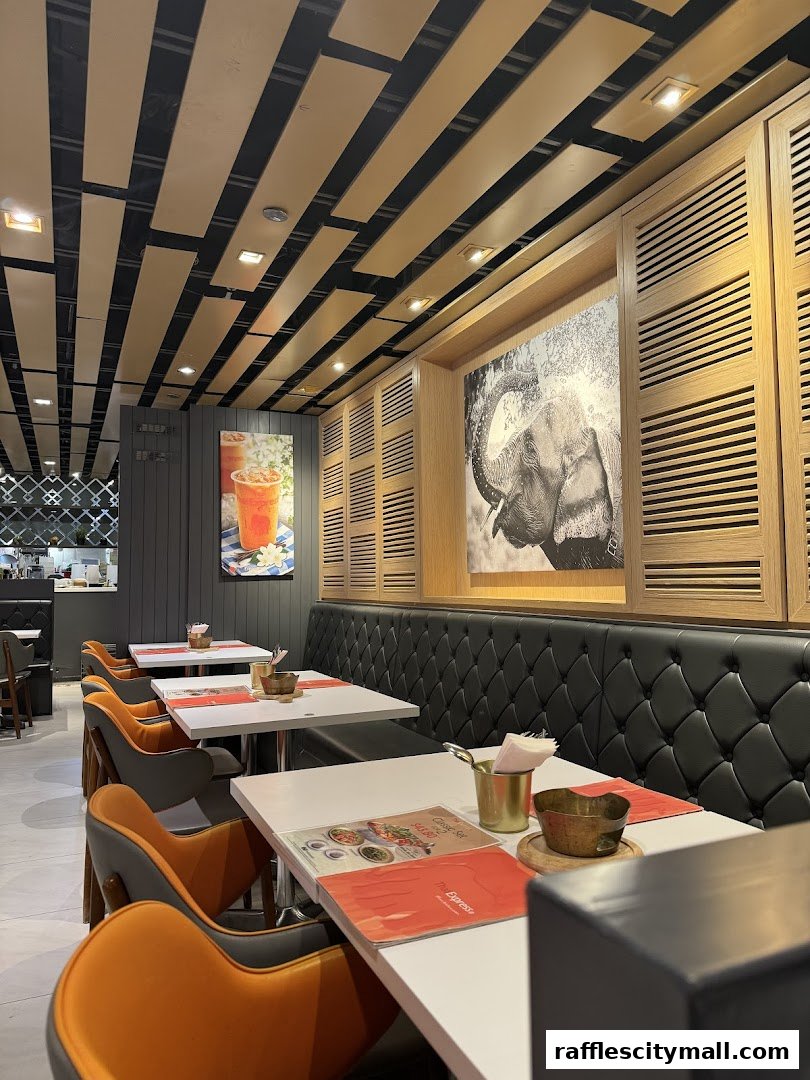 Interior view of Thai Express restaurant with tables, chairs, and elephant artwork.