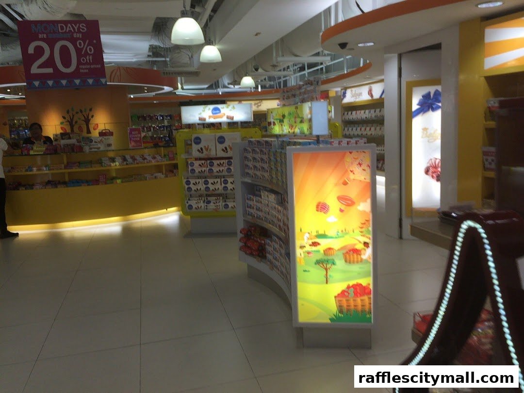 Interior view of The Cocoa Trees shop with colorful displays of chocolates and a promotional sign.
