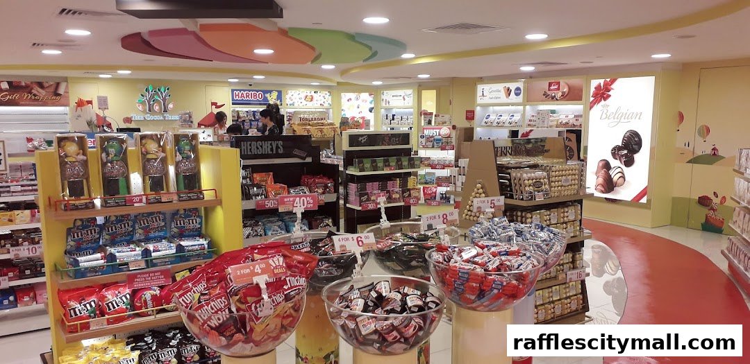 Interior view of a brightly lit confectionery shop with various chocolates and candies on display.