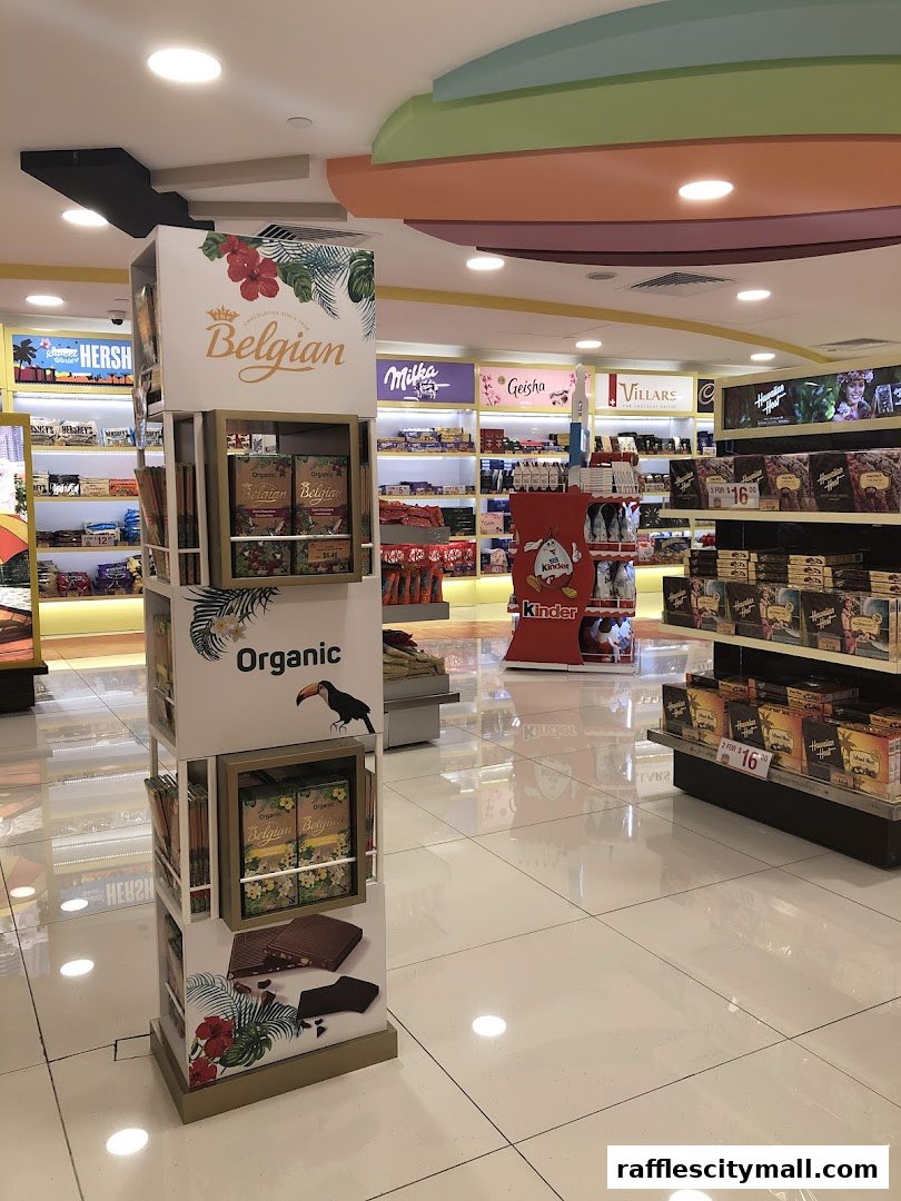 Interior view of a chocolate shop with various brands and products displayed on shelves and stands.