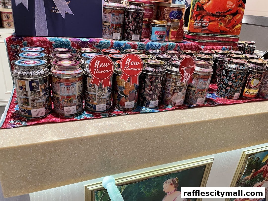 A display of decorative cookie tins with various designs and labels like 'New Flavour' and 'Popular'.