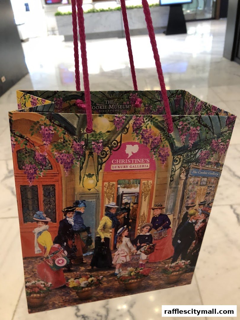 A shopping bag from The Cookie Museum with a vintage street scene illustration.